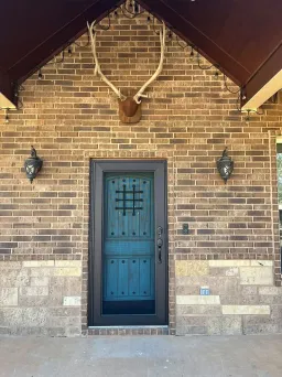Bronze security door by Centurion with resilient stainless mesh for airflow