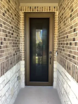 Bronze Centurion security door showing a reinforced frame and protective mesh