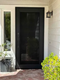 Black Clear Breeze storm door with a full glass view and modern dark frame