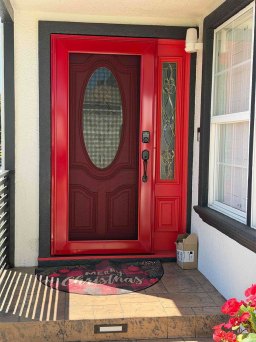 Red modern Centurion security door with stainless mesh and bold exterior styling