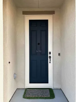 Almond Centurion security screen door with woven steel mesh and a light neutral finish