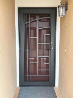 Delta design Artisan security door in black with decorative metalwork and airflow mesh