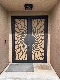 Matte black Artisan security door with modern design and reinforced mesh on front entry