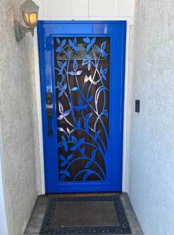 Gloss blue Artisan security door with ivy design and reflective finish on residential entry