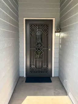 Grey Artisan security door with deco pattern and breathable stainless mesh on front entry