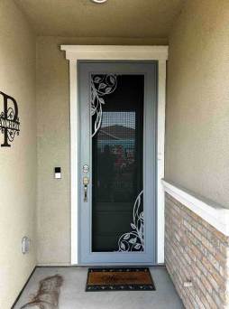 Grey Artisan security door with terra design installed on front door with modern exterior finish