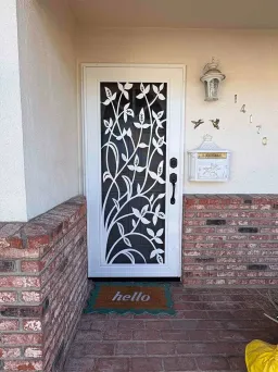 White Artisan security door with England design and airflow mesh installed on front entry