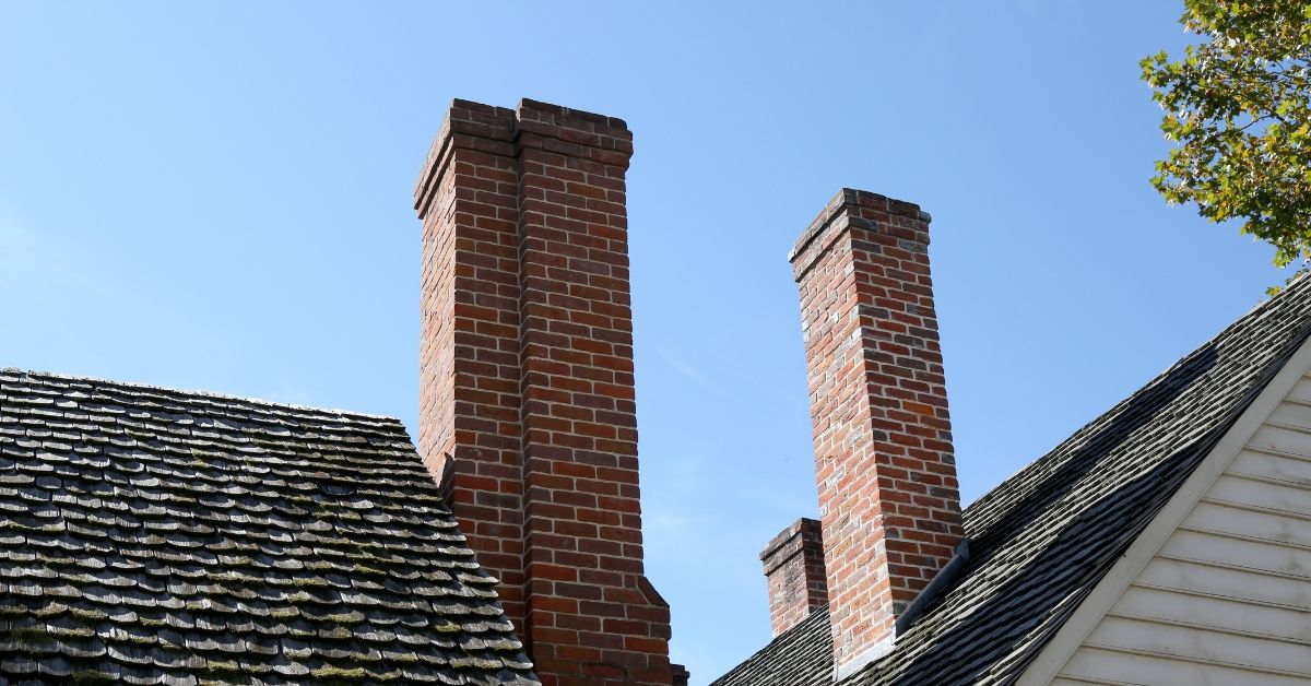 two-brick-chimneys-how-long-should-i-wait-to-get-chimney-repairs-den-defenders